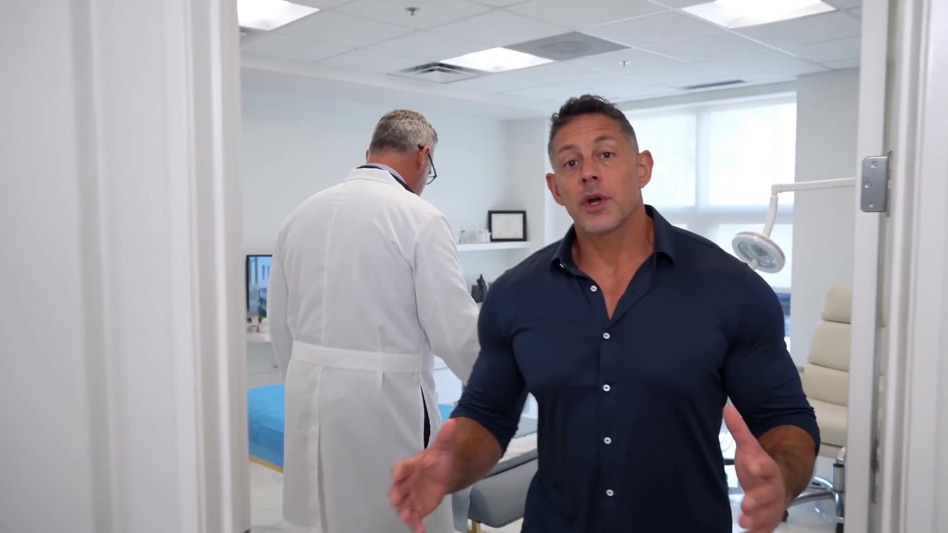 Mike Brown consulting with a physician inside a wellness clinic exam room